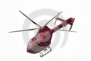 Red helicopter of air ambulance isolated on white background, London - UK
