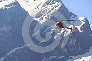 Red helicopter and Himalaya Annapurna mountain, Nepal