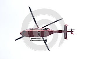 Red helicopter isolated in the sky