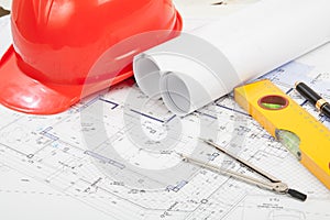 Red helmet, construction drafts and tools