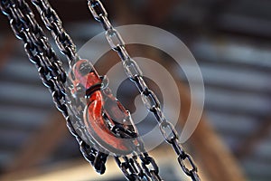 Red hoist and chain on background