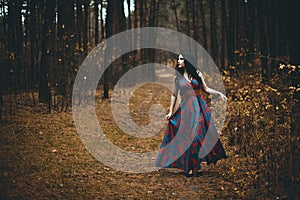 Red Hooded Woman Holding Apple Fairytale Portrait - Fairytale image of a beautiful  girl wearing a red hood near the forest
