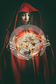 Red hooded woman with magical wooden toy