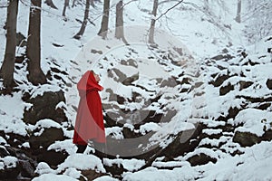 Red hooded woman in a snowy forest