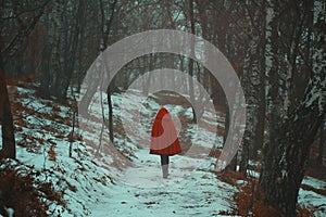 Red hooded woman walks alone