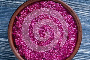 Red horseradish sauce with beetroot isolated on wooden background, closeup, top view. Concept of healthy eating