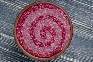 Red horseradish sauce with beetroot isolated on wooden background, closeup, top view. Concept of healthy eating