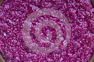 Red horseradish sauce with beetroot isolated on wooden background, closeup, top view. Concept of healthy eating