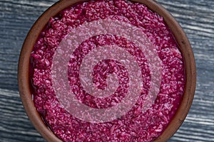 Red horseradish sauce with beetroot isolated on wooden background, closeup, top view. Concept of healthy eating