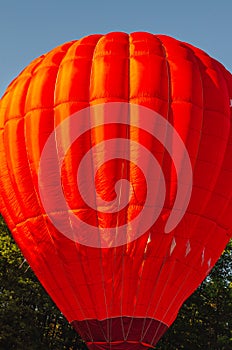 Red hot air balloon against the blue sky