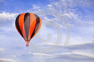 Red hot air balloon flying on blue sky