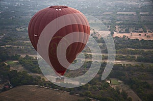 Red Hot Air Balloon Over Asian Countryside Bagan, Myanmar (Burma).