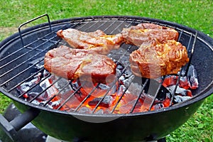 Red hot charcoals and steaks on charcoal grill