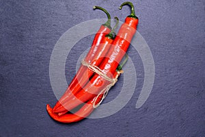 Red hot chili pepper on a dark vintage culinary background, top view. copy space