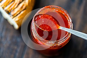 Red Hot Chili Pepper Sauce for Artisan Cheese made with Vinegar and Sugar in Glass Bowl with Spoon