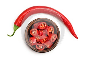 red hot chili pepper slices in ceramic bowl isolated on white background. Top view. Flat lay.