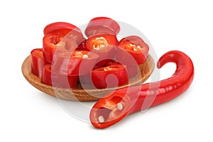 red hot chili pepper slices in wooden bowl isolated on white background