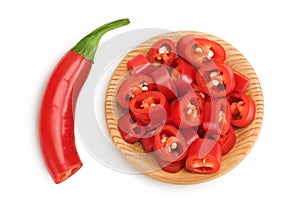 red hot chili pepper slices in wooden bowl isolated on white background. Top view. Flat lay.