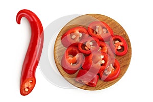 red hot chili pepper slices in wooden bowl isolated on white background. Top view. Flat lay.