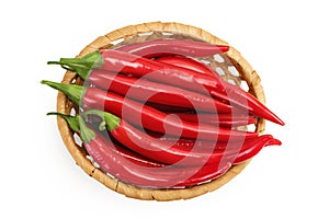 red hot chili pepper in wicker basket isolated on white background. Top view. Flat lay.
