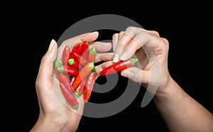 Red hot chili pepper in woman's hands