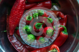 Red hot chili peppers in glass container, background close-up