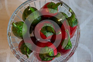 Red hot chili peppers in glass container, background close-up