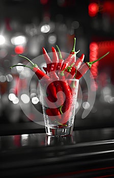 Red hot chili peppers in glass. A glass of red hot chili peppers in a glass