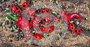 Red hot chili peppers and a mixture of different peppers on a wooden table. traditional spices.