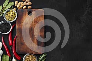 Red hot chili peppers and other spices on dark background