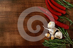 Red hot chili peppers and other spices on dark background