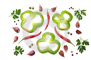 red hot chili peppers with parsley, garlic and cut slices of green sweet bell pepper isolated on white background top view