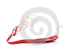 A red hot chili peppers with red smoke on a white background, close up