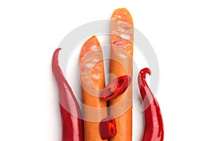 Red hot chili peppers and sausages for frying isolated on white background