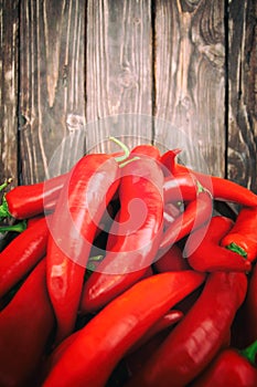 Red hot chili peppers on wood background