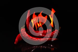 Red hot chili spice `burning peppers on a black background`