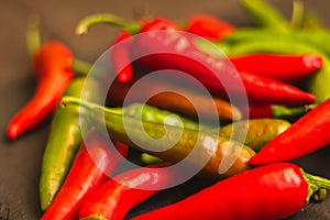 Red hot chilli peppers. Heap of red and green pepper. Bright natural background. Cayenne peppers. Colourful spicy peppers