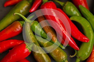 Red hot chilli peppers. Heap of red and green pepper. Bright natural background. Cayenne peppers. Colourful spicy peppers