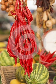 Red hot chillies hanging at Market stall