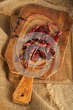 Red hot chillies pepper on wooden board