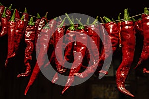 Red hot chilly pepper drying on wire