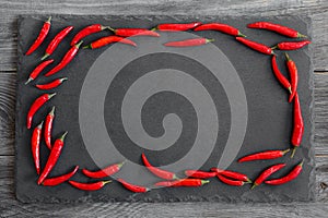 Red hot chilly peppers on grey background with copy space for your text.