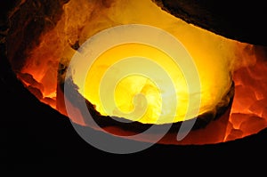 Red hot crucible with molten metal
