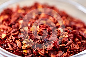 Red hot dried chilly pepper background, close-up, top view, macro, shallow depth of field.