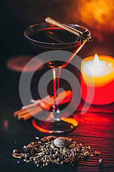 Red hot drink glintwein with spices, cinnamon, anise, fruits, brown sugar on an old wooden table. New Year and Christmas holidays