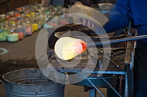 Red-hot glass at the blowpipe photo