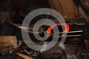 Red hot horseshoe on the anvil