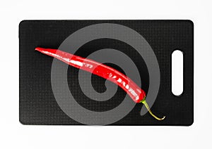 Red hot pepper on a black cutting board