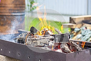 Red-hot pieces of coal and flames in a cooking brazier.