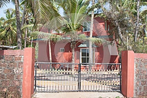 Red house behind a fence